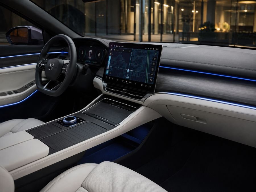 Modern EV dashboard display showing navigation maps, touchscreen interface, ambient lighting, digital gauge cluster, premium interior quality