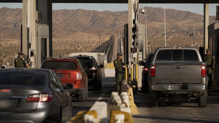 Vehicles queued at a US-Mexico border crossing inspection checkpoint